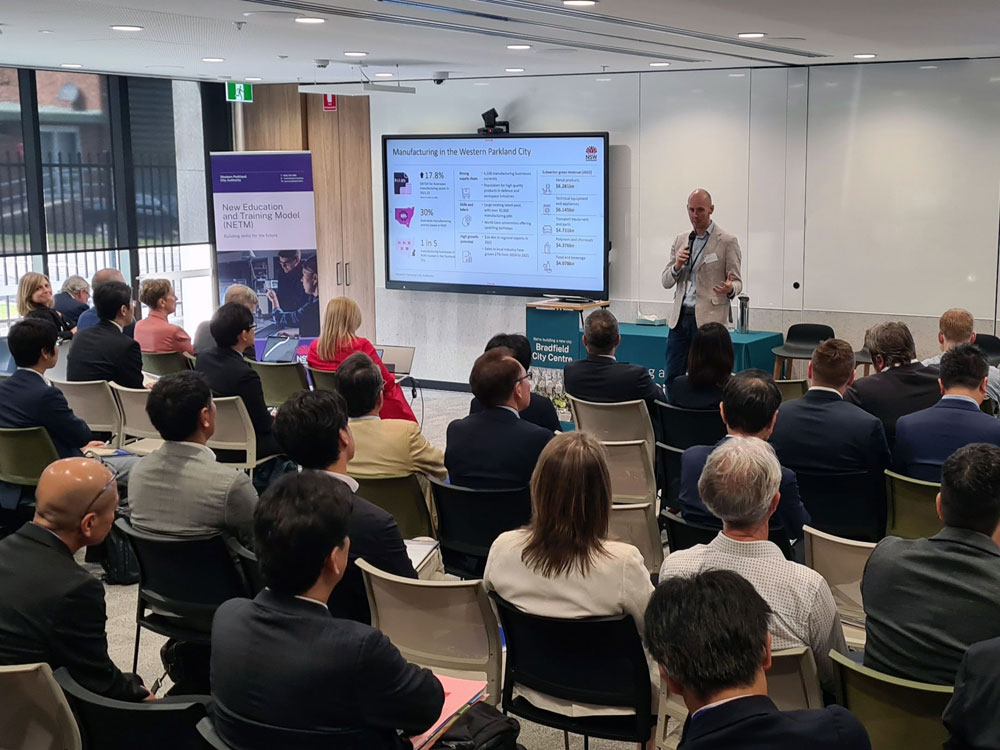 A man delivering a presentation to a group of business people