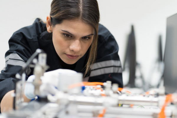 Female engineer training AI robot