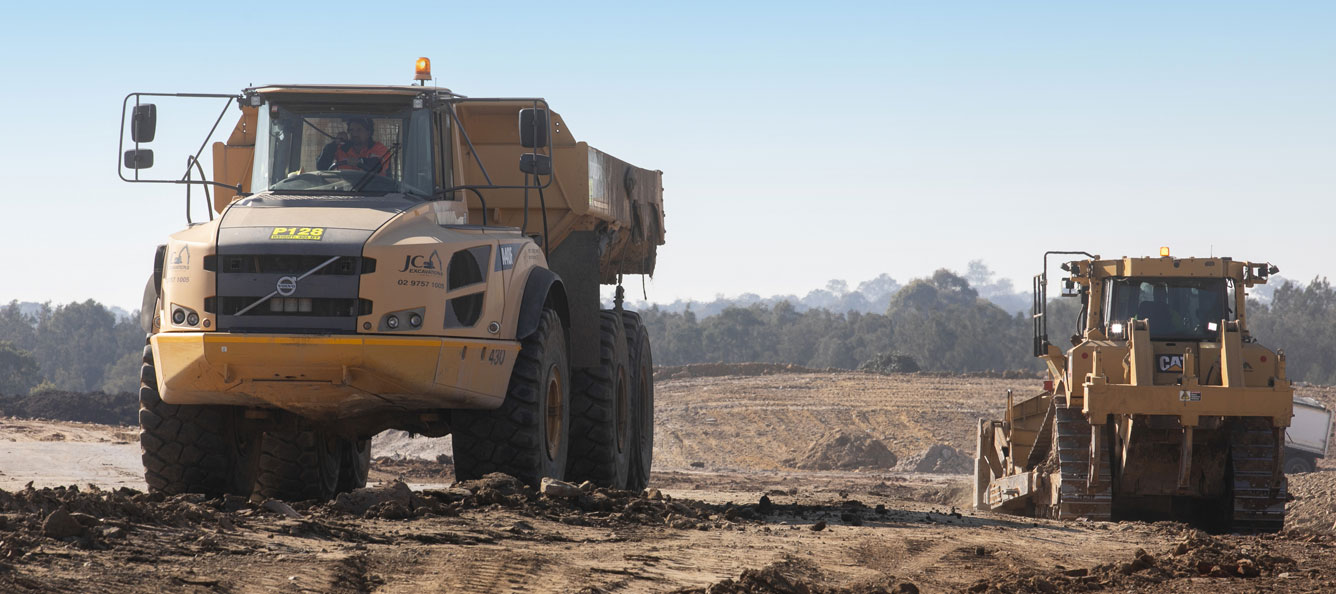 Earth moving trucks on a construction site enabling works