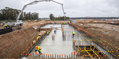 The concrete slab being poured at the construction site of the First Building in Bradfield City Centre.